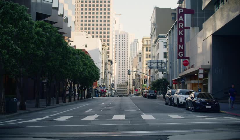 A city street with vehicles people and buildings