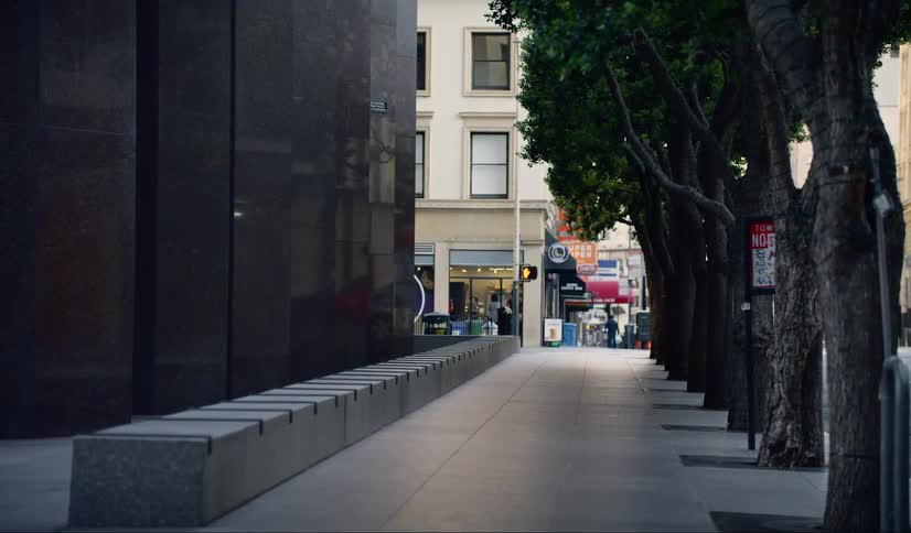 The city street is empty by the buildings