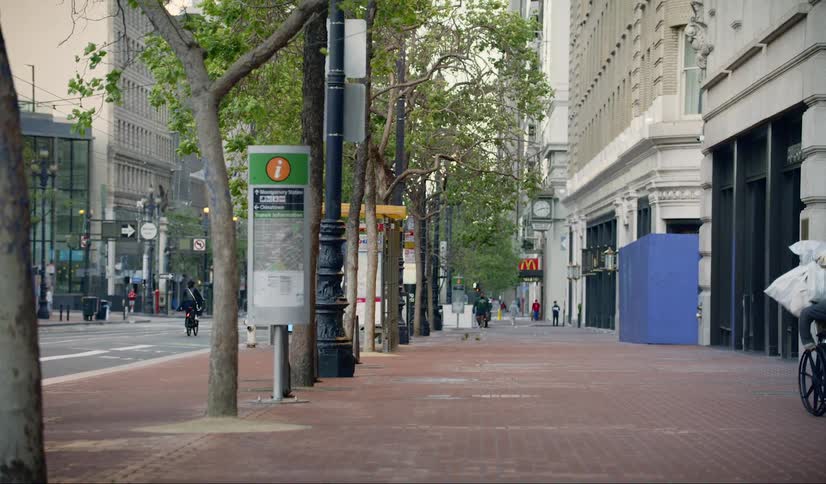 Messenger riding bicycle in city empty streets