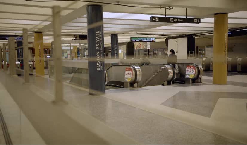 People walk onto an escalator