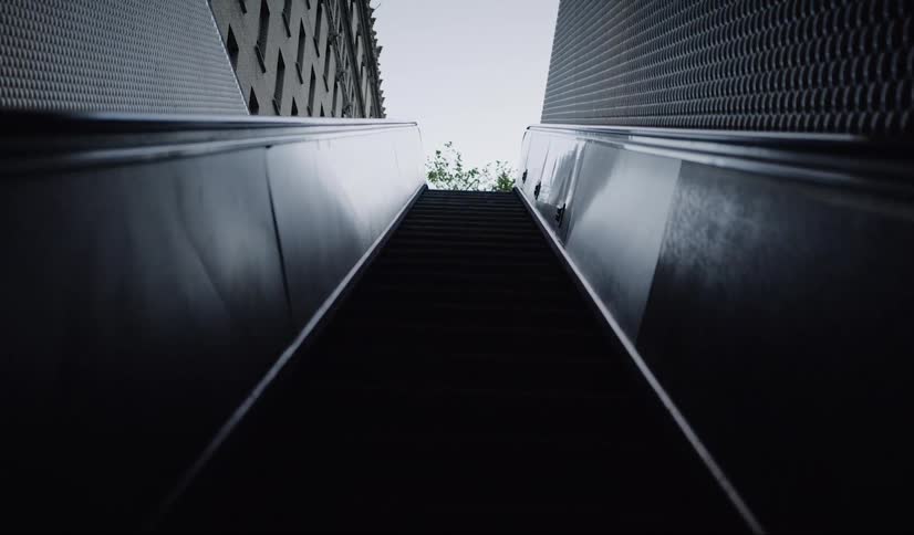 Escalator coming out of subway station in city downtown