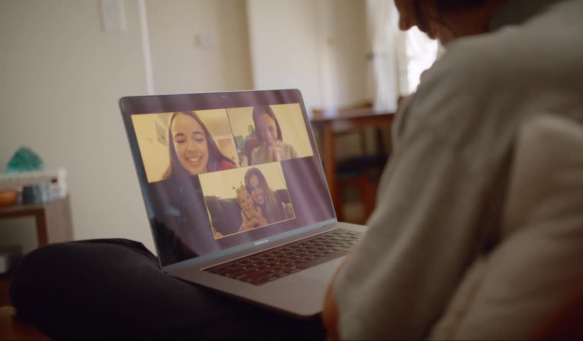 Woman makes a video call with her friends in the living room at home