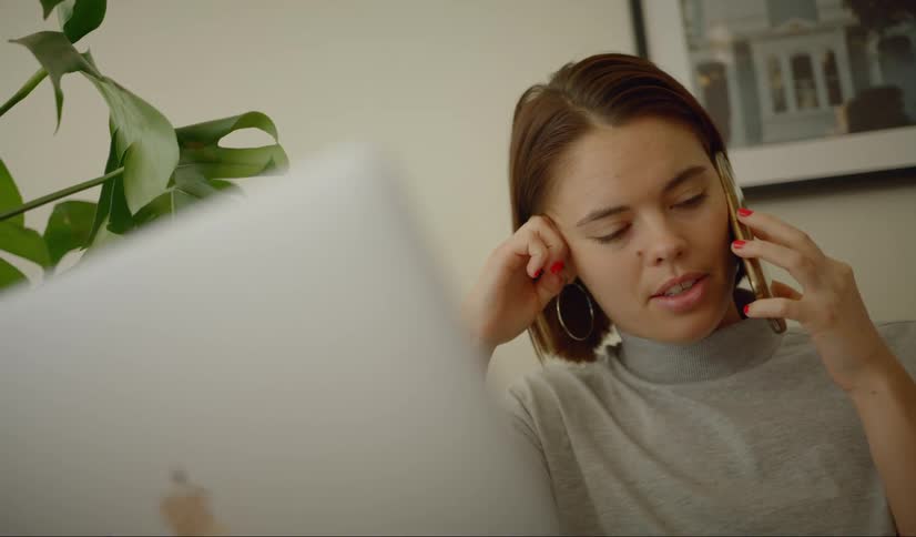 A woman talks on the cell phone in a home