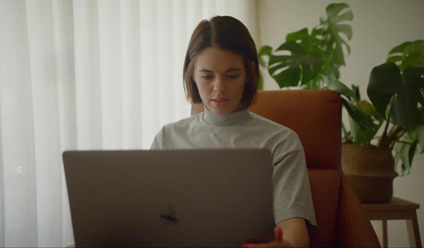 A woman uses her laptop in an office