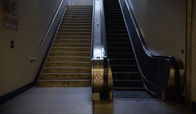 The escalator and staircase is empty in the building
