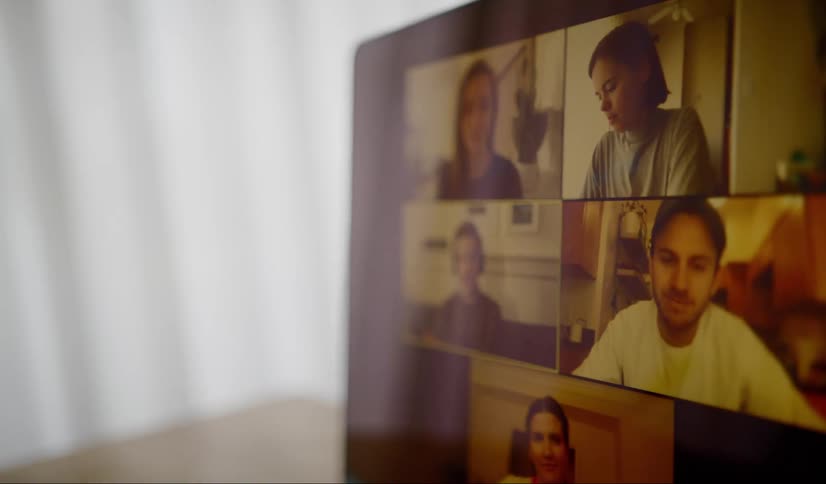 Participating in team video conference next to window
