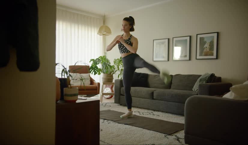 Woman works out in the living room at home