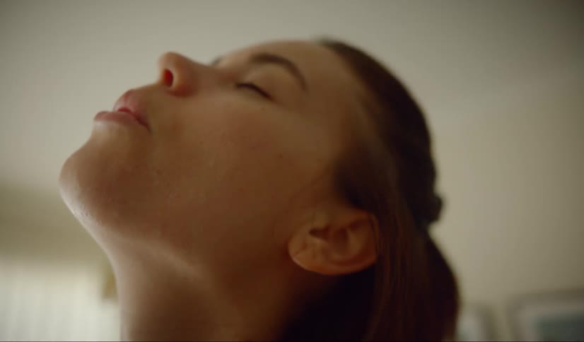 A young woman stretching her neck and arm muscles