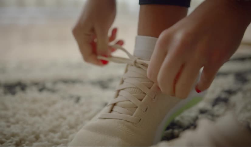 A teenager ties her shoes