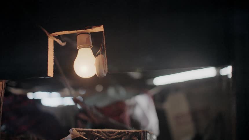 A person reaches over to turn on the light
