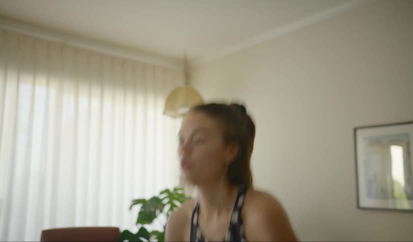 A woman is exercising in her living room