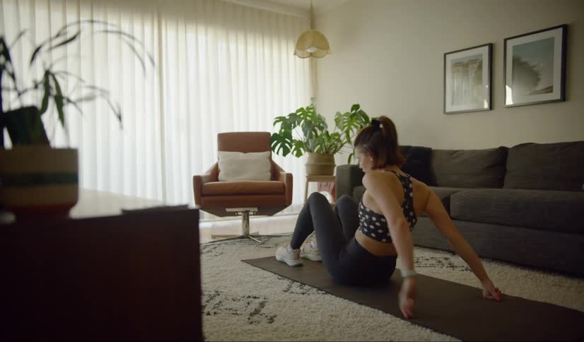 A young woman stretching on a mat