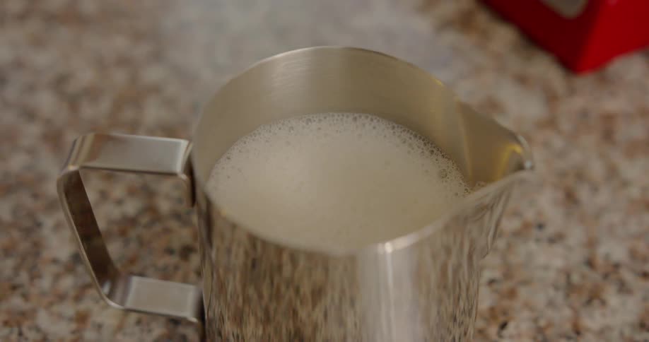Milk in metal jar on kitchen counter top