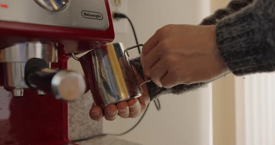 Man prepares coffee on espresso machine in the kitchen