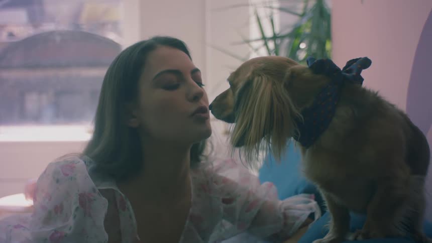 A woman gives her dog a kiss