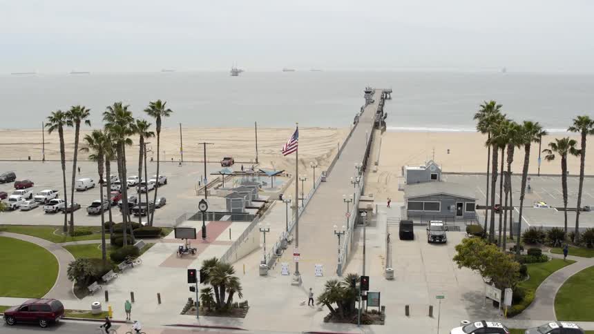 United states flag waving on boardwalk near beach at day