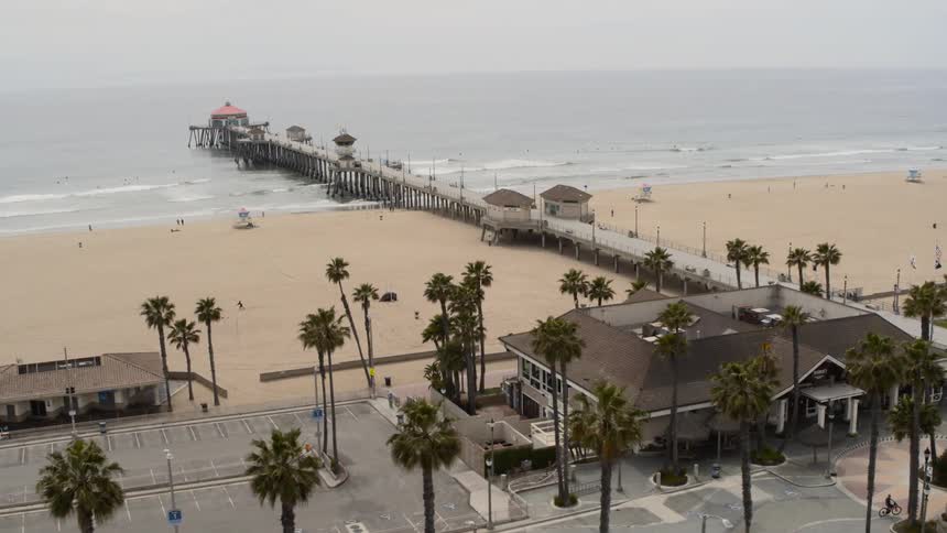 A pier near the beach with trees and sand