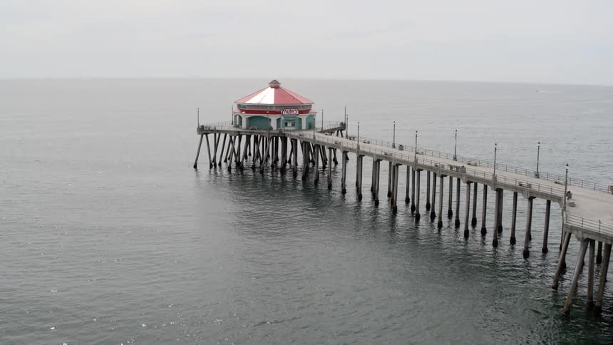 A pier leading out to a store extends out into open water