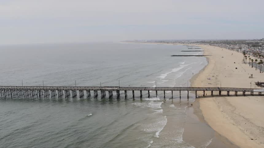 A pier leading out to a shelter extends out into open water