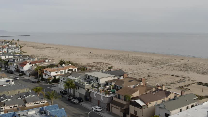 Aerial view of beachfront neighborhood with beach at day