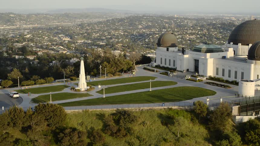 The closed and empty griffith observatory with the la skyline on the horizon