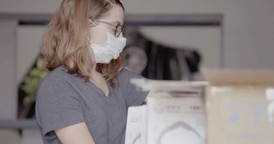 A teenager stands with a mask on