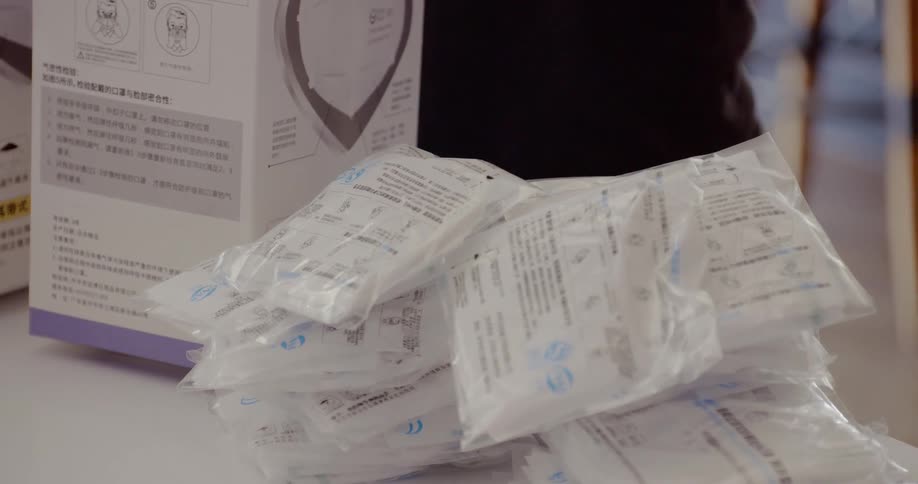 A woman unloads a box of medical supplies