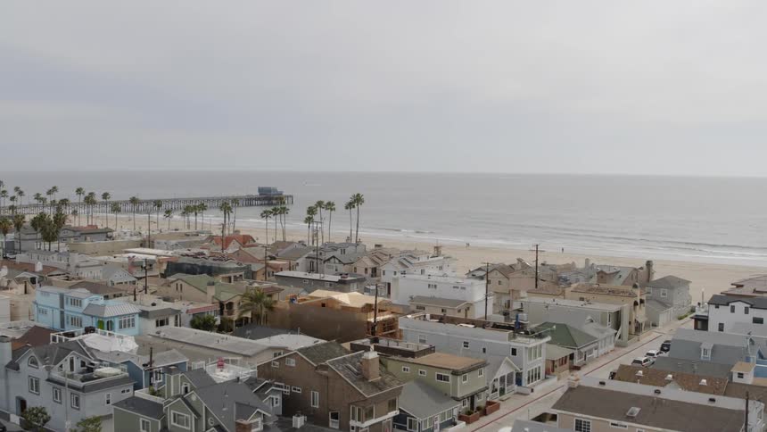 A coastal neighbourhood and sandy beach viewed from above