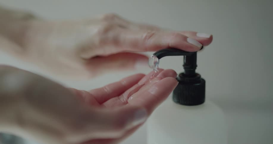 A woman dispenses soap in to her hand