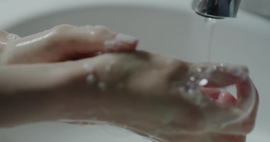 A person thoroughly washing their hands