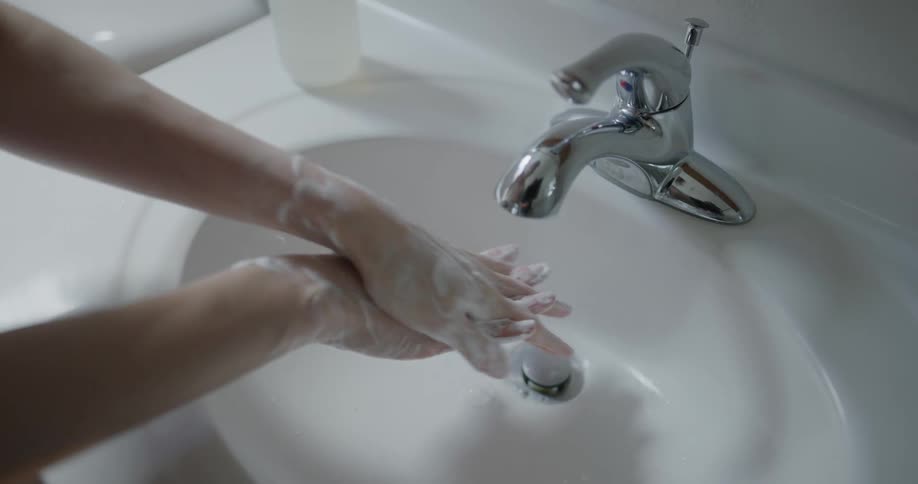 A person is washing their hands in the sink