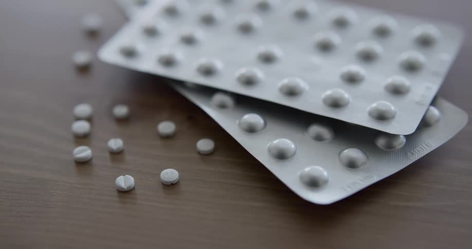 Packages of pills sitting on a table