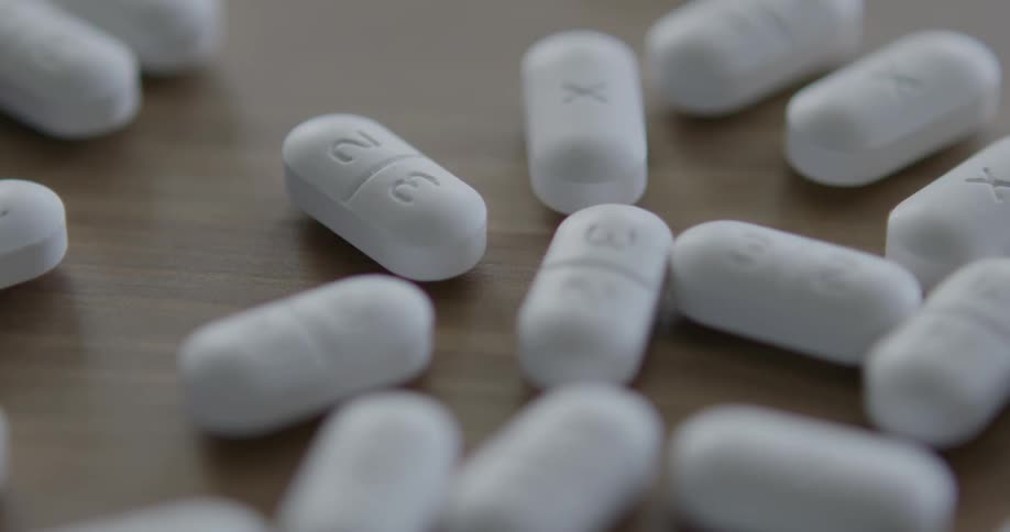 White prescription drugs scattered on the table