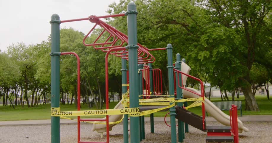 Playground on park surrounded by caution yellow tape