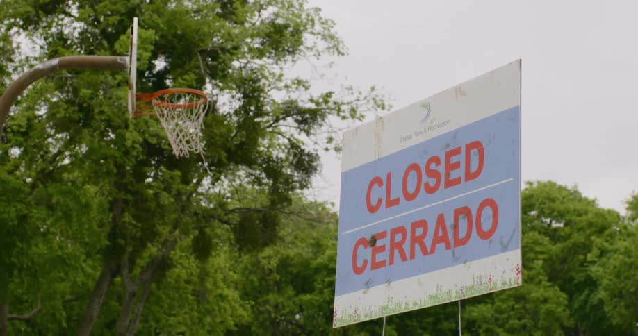 Basketball hoop in public park with a closed sign in front