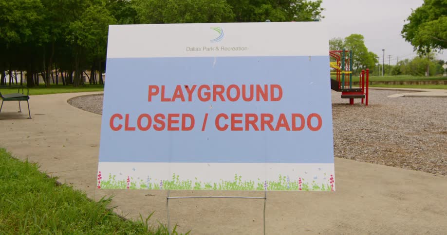 Close up of signage at park stating playground is closed