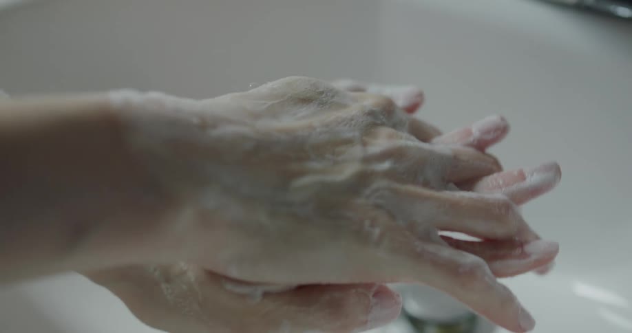 A person is washing their hands with soap