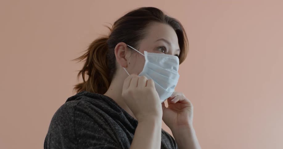 Woman wears a face mask as a precaution due to corona virus