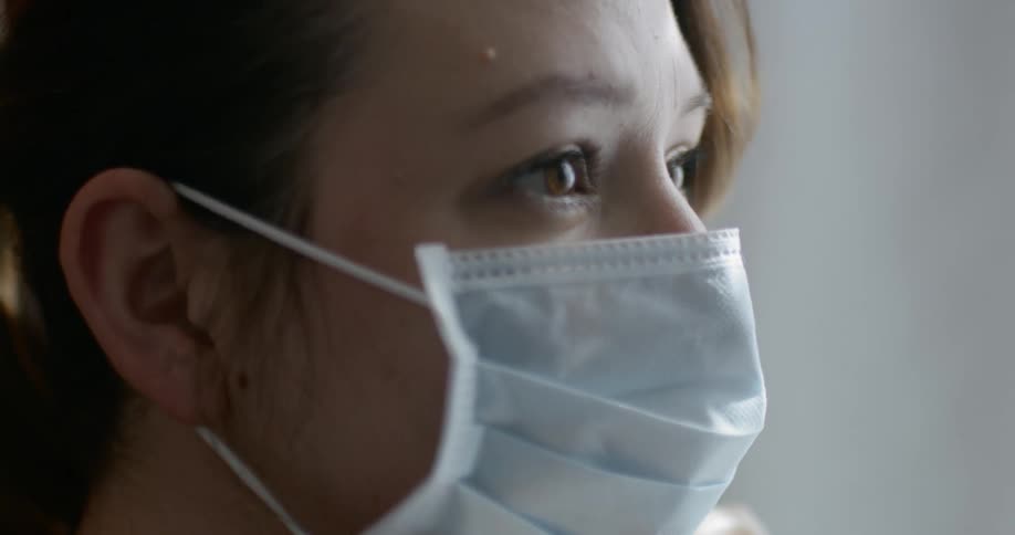 Asian woman wears a white face mask as a precaution for coronavirus