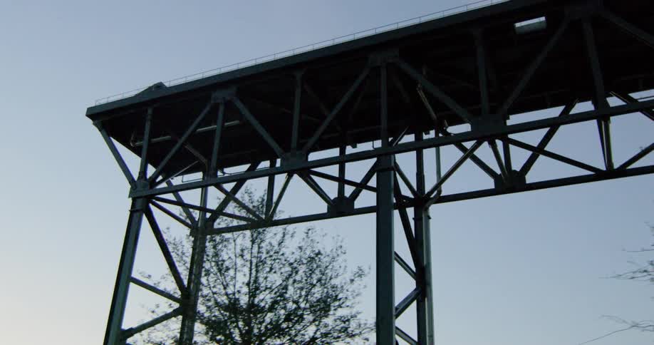 Metallic structure on city at sunset