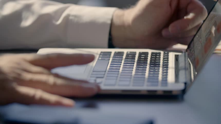 A person works on a laptop