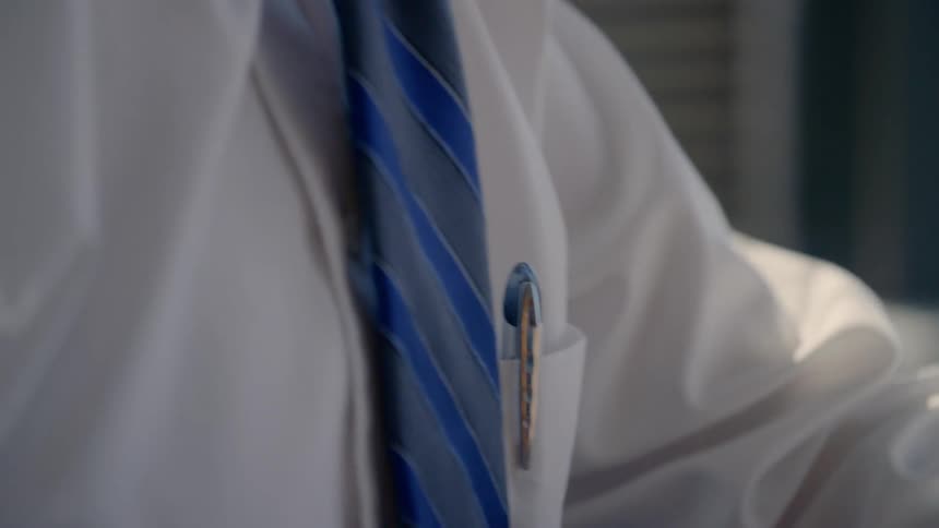 Close up view of a pen in a mans shirt pocket