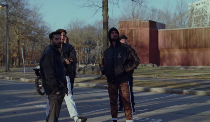 A man retrieves a rifle from his car and begins shooting as his friends watch
