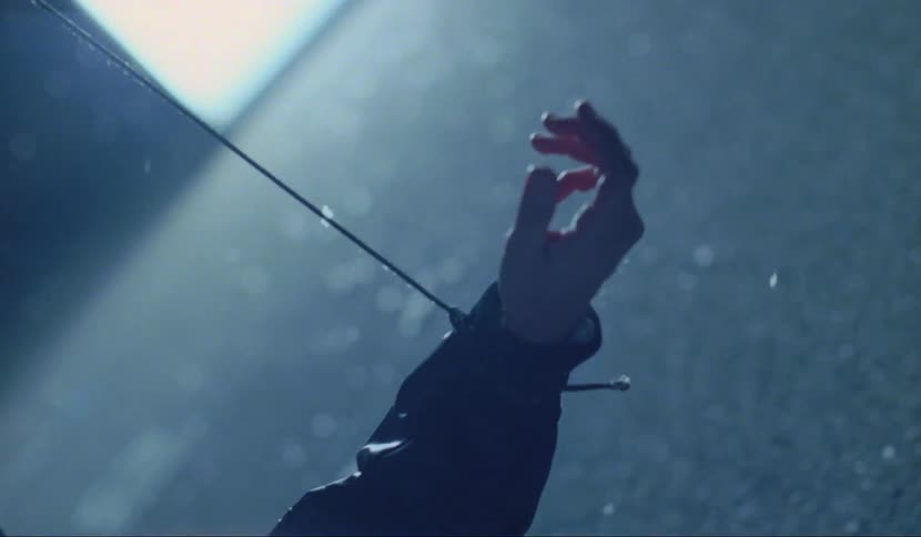 A person appears to be tied up with string around their wrist