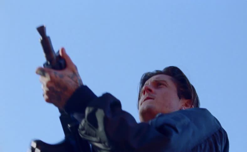 A man shoots an assault rifle while yelling outside