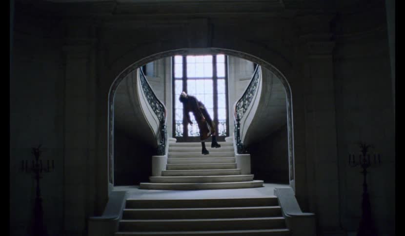 A young girl hangs in a stairwell
