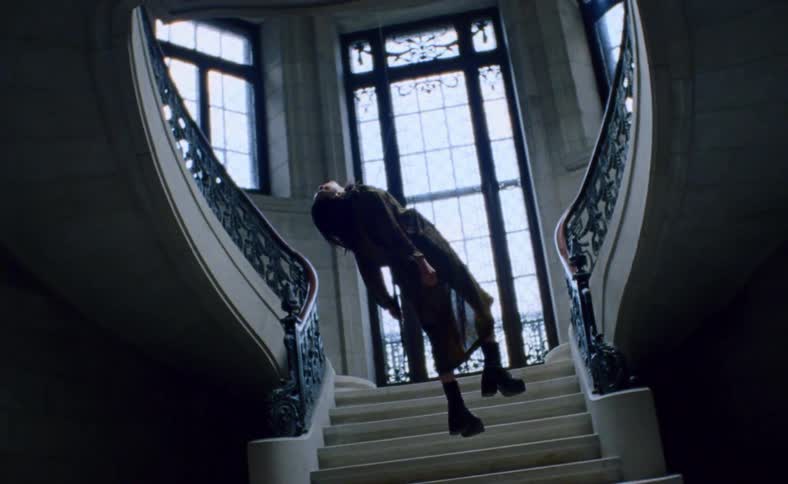 Woman levitating in front of a stairwell
