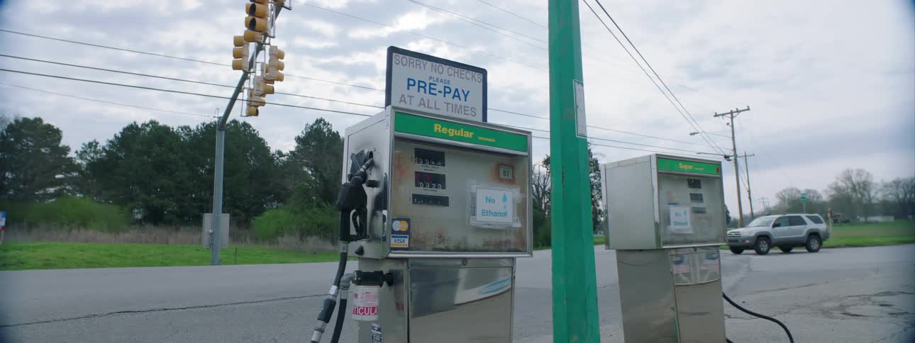 Gasoline pumps sit next to a street