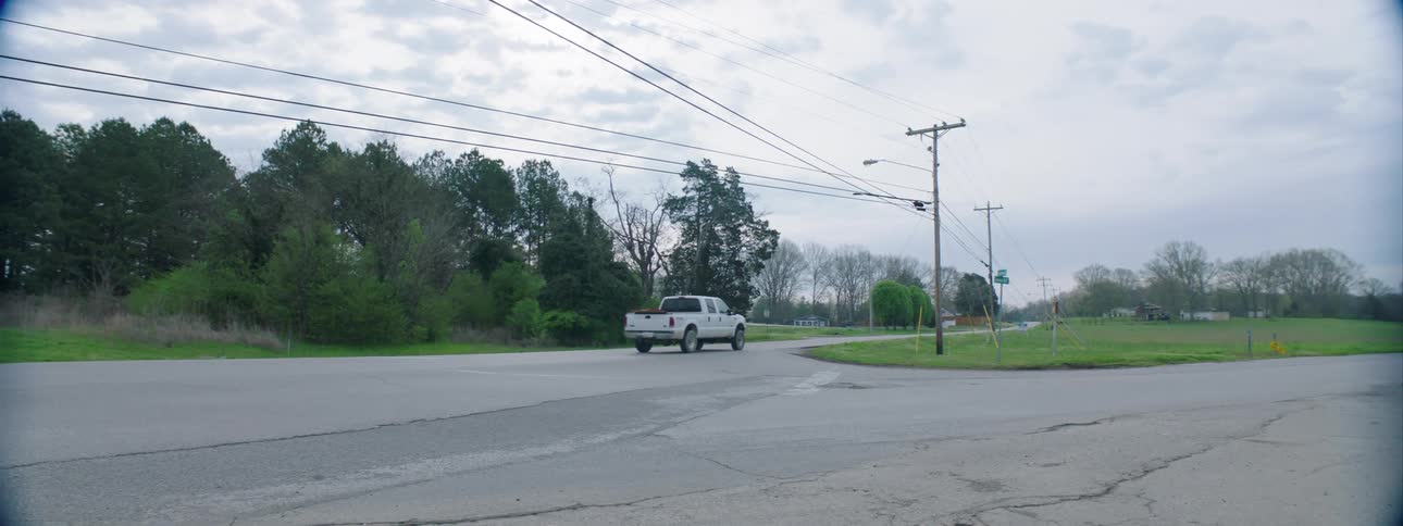 A white pickup truck driving on the road