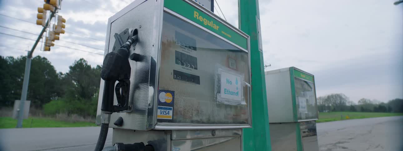 Gas station pumps stand near highway